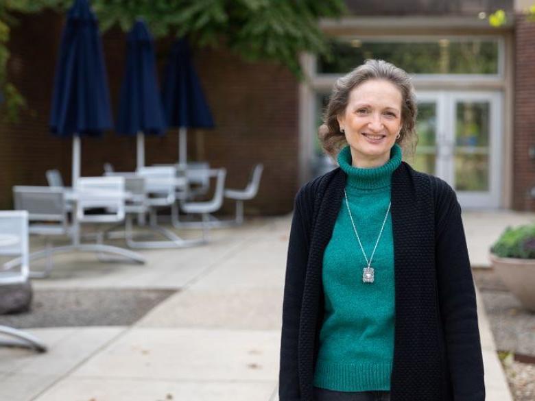 Adult student Neesa Fahy smiling in front of the Main Building.